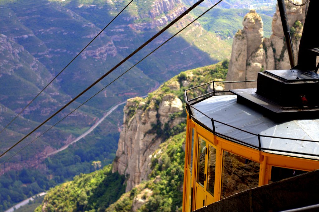Yellow cable car crossing the valley into Montserrat